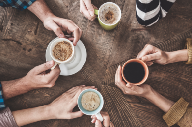 A top down view looking at people drinking coffee at a table