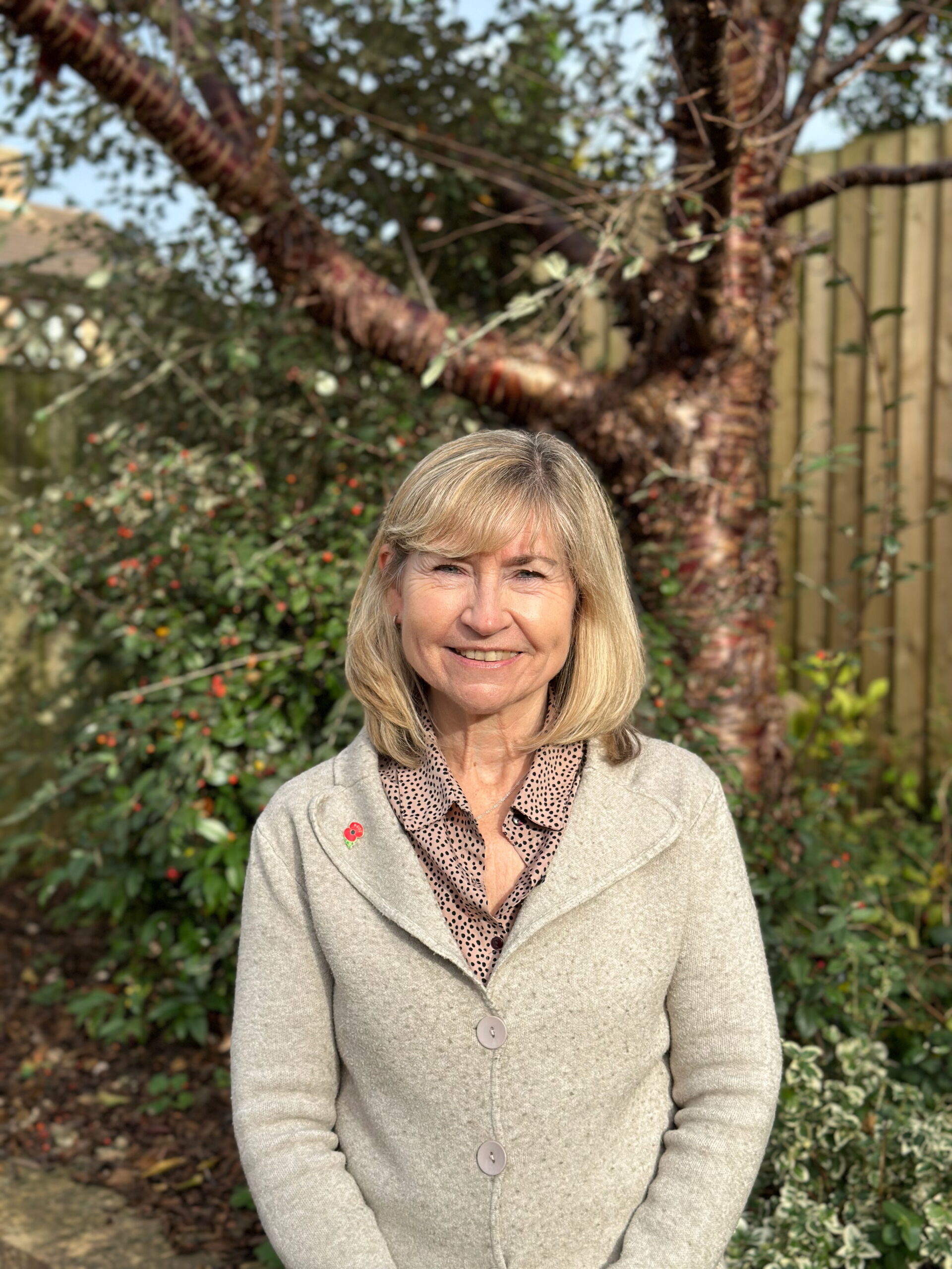 Gail standing in front of a tree