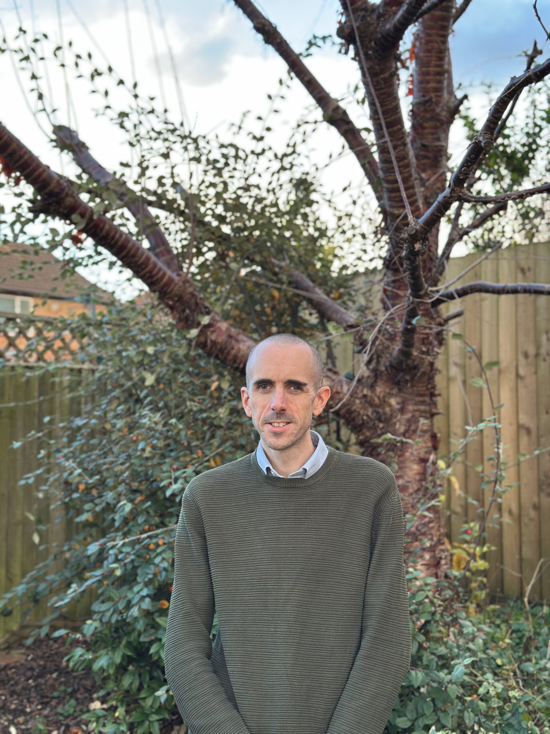 Mark standing in front of a tree