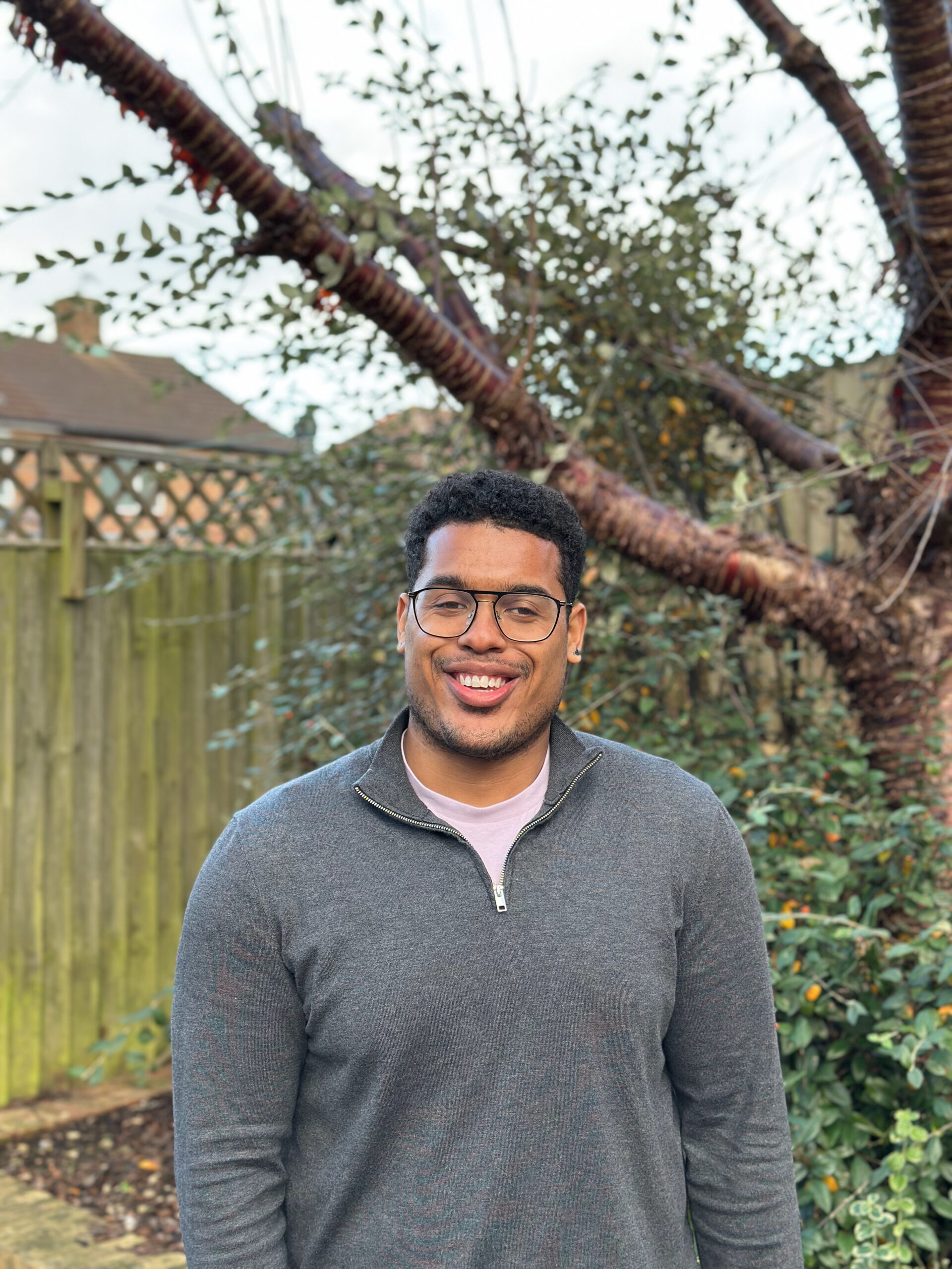 Devante standing in front of a tree