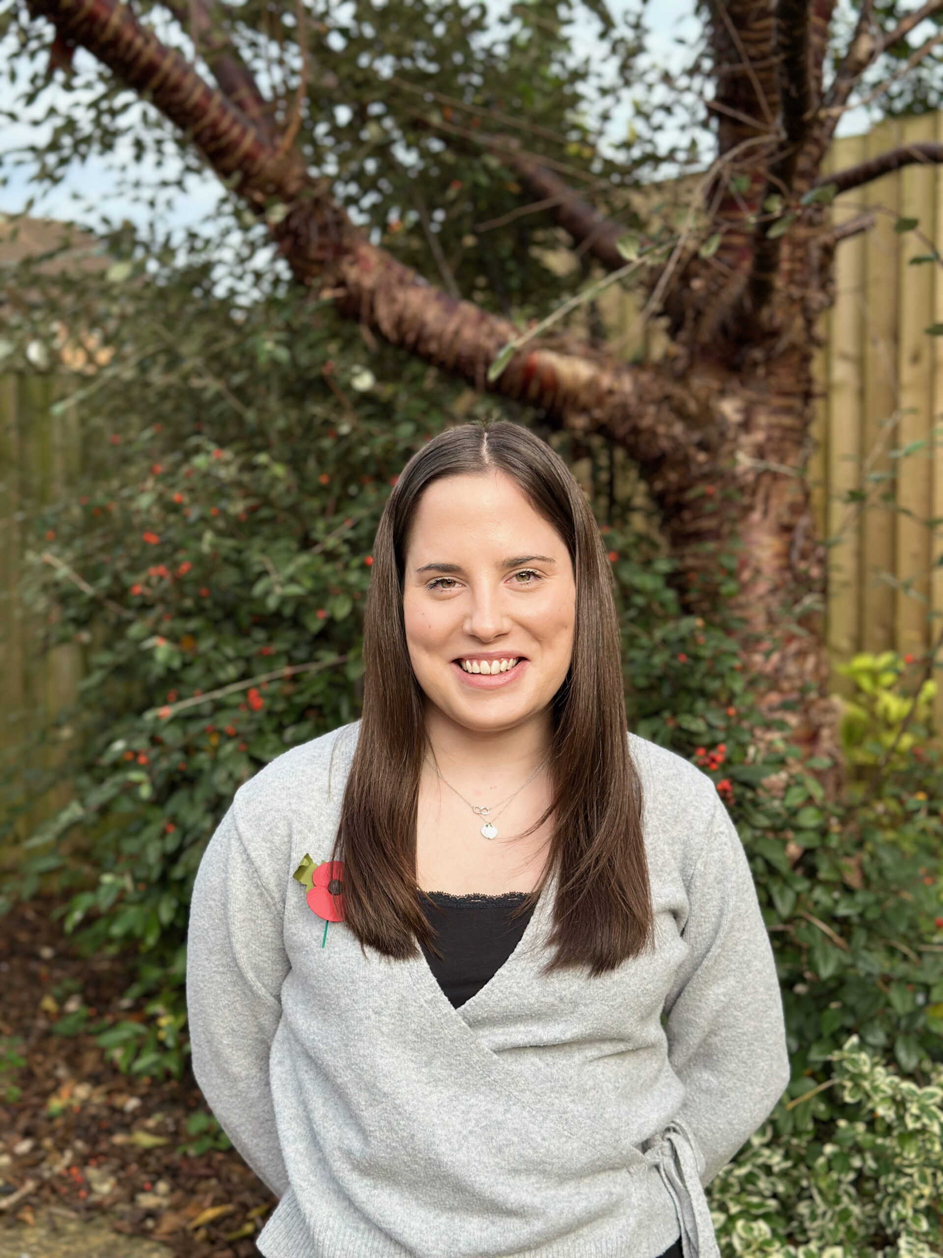 Katie standing in front of a tree