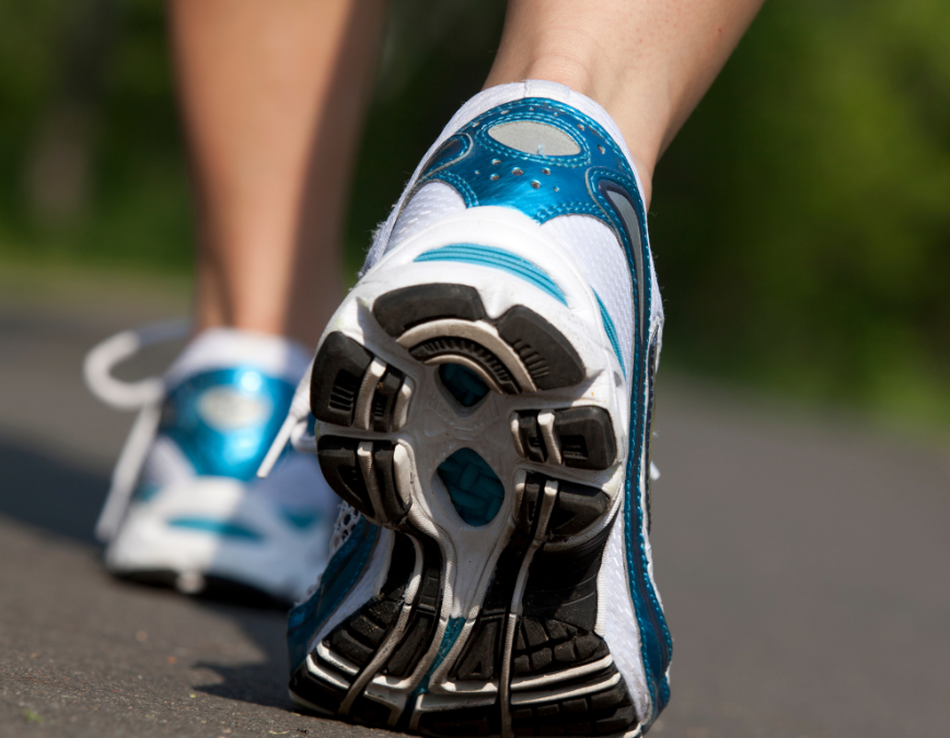 A close-up of a person's shoes while they are running