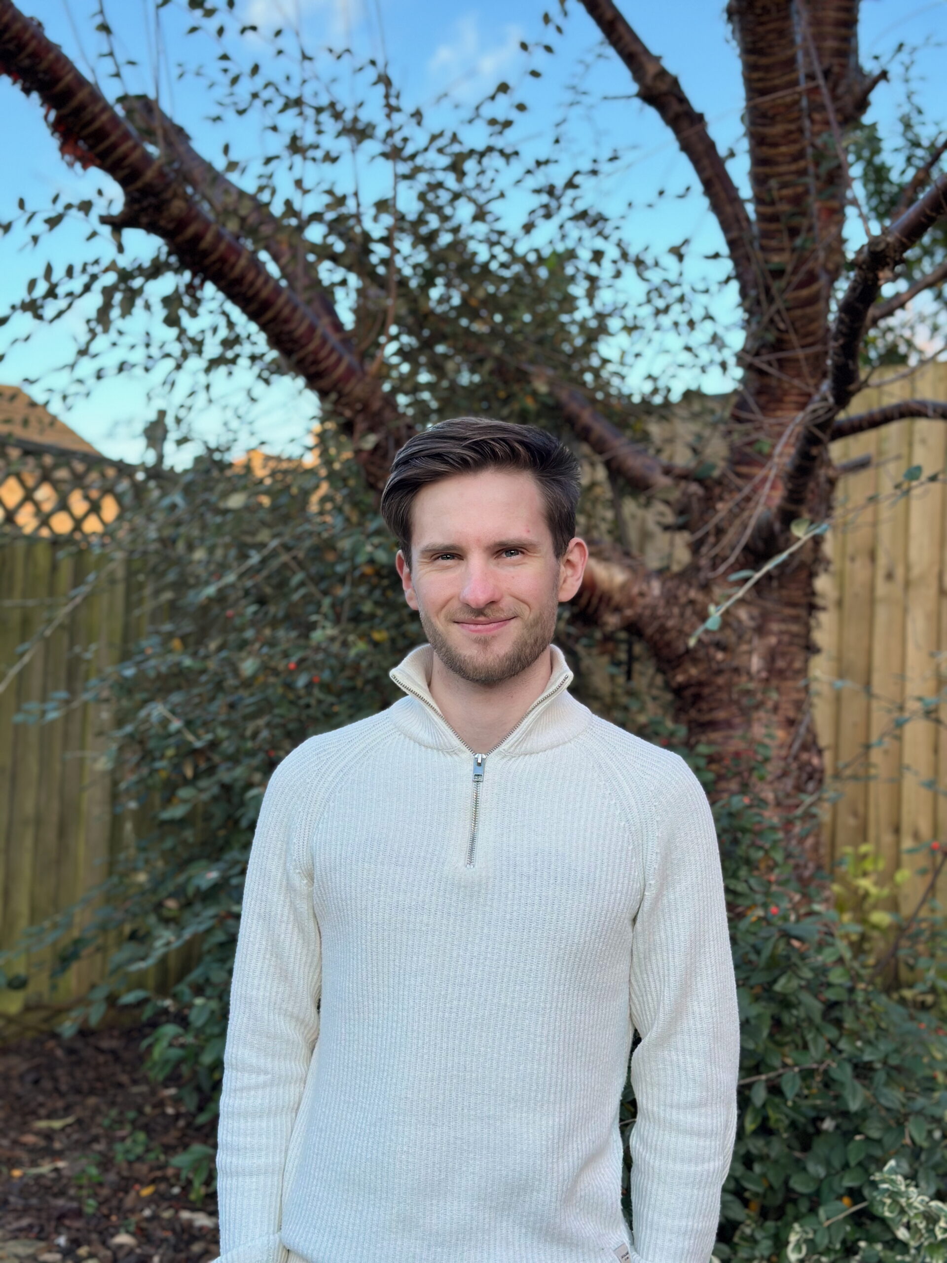 George standing in front of a tree