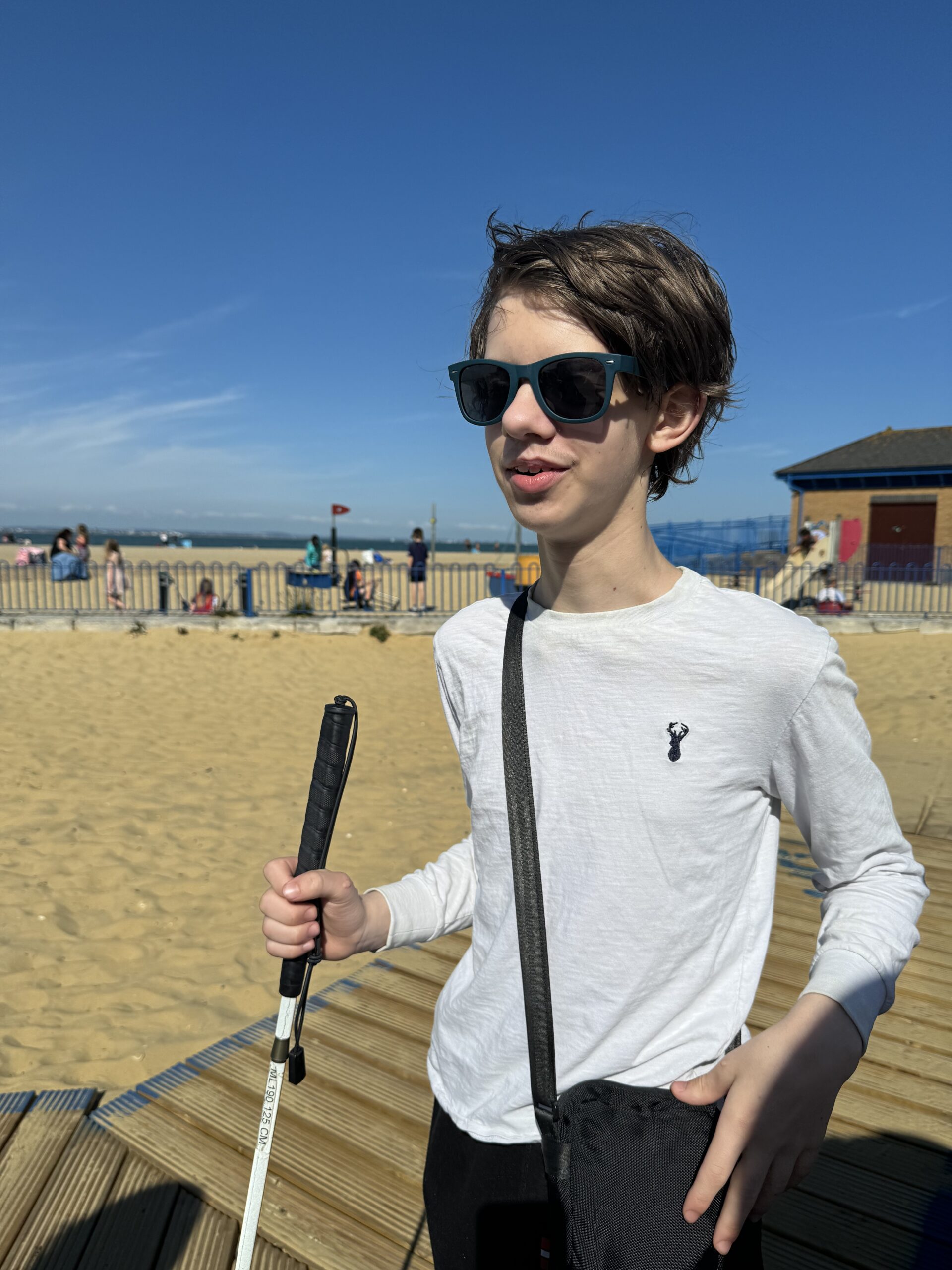 Daniel, with his white cane, at the beach