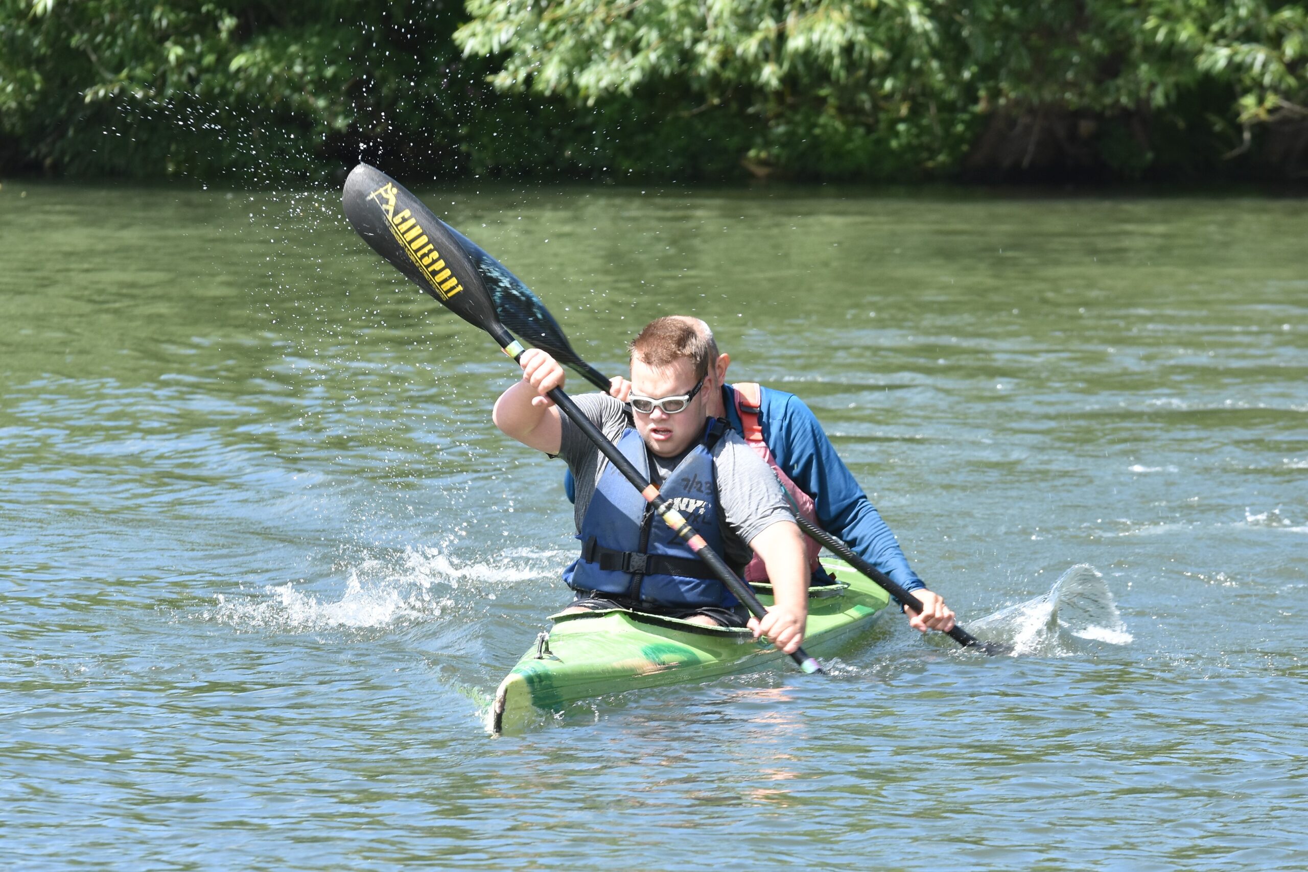 a child kayaking on the river