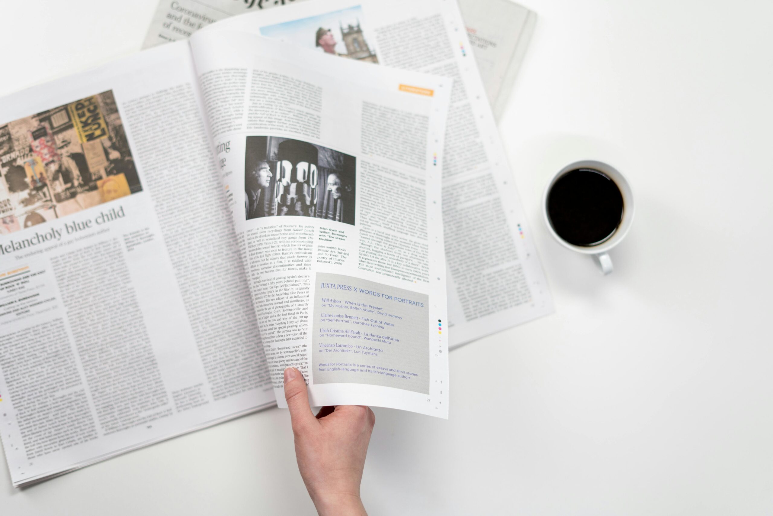 photo of a newspaper and a coffee