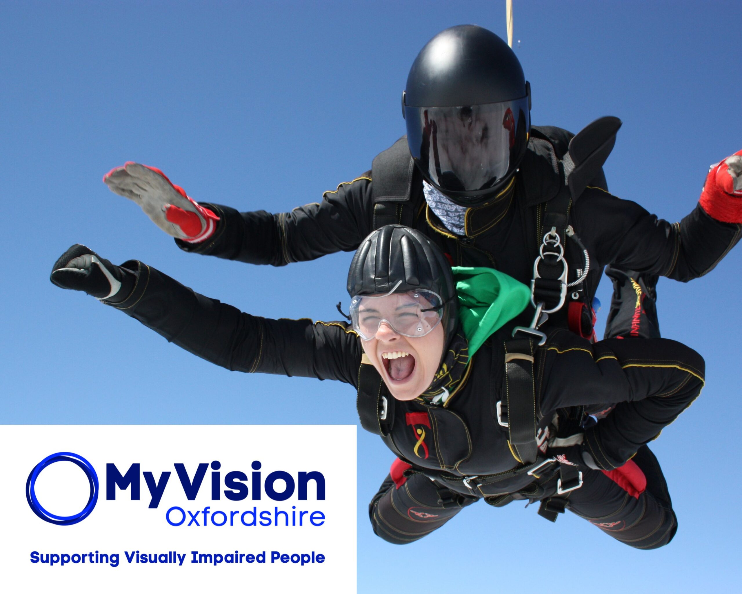 Photo of two people skydiving. The MyVision logo is in the bottom left corner